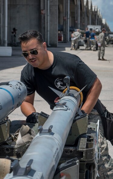 U.S. Air Force Senior Airman Israel Vasquez, 120th Fighter Squadron weapons load team crew member, inspects an AIM-9 sidewinder missile during a quarterly weapons load competition June 23, 2017, at Kadena Air Base, Japan. The Colorado Air National Guard Fighter Squadron, from Buckley Air Force Base, Colo., is touring Kadena as part of a theater security package. (U.S. Air Force photo by Senior Airman John Linzmeier)