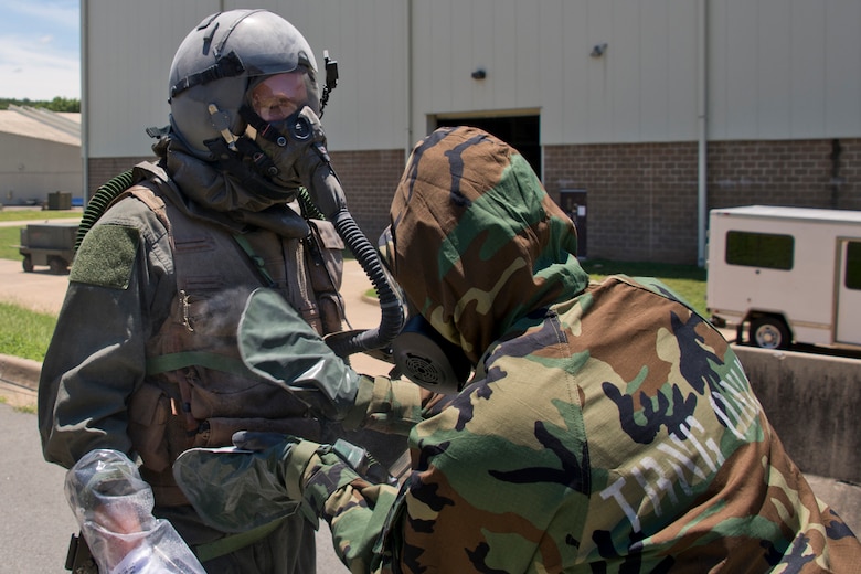 U.S. Air Force Reserve Staff Sgt. Casey Godwin, aircrew flight equipment (AFE) specialist, 327th Operations Support Squadron, pats down Staff Sgt. Michael Hopson, loadmaster, 327th Airlift Squadron, with activated charcoal from a M295 Individual Decontamination Kit during a training scenario June 19, 2017, at Little Rock Air Force Base, Ark. The training required the construction of several Lightweight Inflatable Decontamination Systems (LIDS) shelters and the removal of simulated contaminants from three aircrew members. (U.S. Air Force photo by Master Sgt. Jeff Walston/Released)