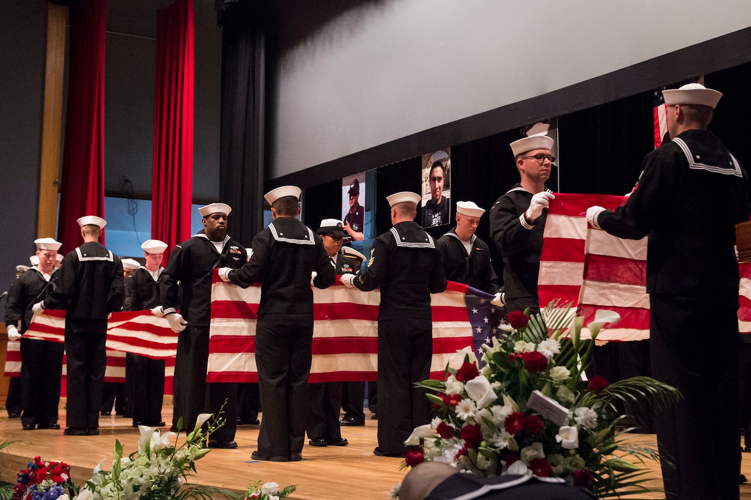 YOKOSUKA, Japan (June 27, 2017) Sailors ceremonially fold seven American flags during a memorial ceremony at Fleet Activities (FLEACT) Yokosuka for seven Sailors assigned to Arleigh Burke-class guided-missile destroyer USS Fitzgerald (DDG 62) who were killed in a collision at sea, June 17. (U.S. Navy photo by Mass Communication Specialist 2nd Class Raymond D. Diaz III/Released)
