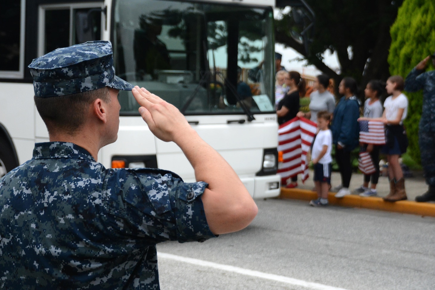 YOKOSUKA, Japan (June 27, 2017) The Fleet Activities (FLEACT) Yokosuka community forms a line of honor supporting the family and shipmates of the seven Sailors assigned to Arleigh Burke-class guided-missile destroyer USS Fitzgerald (DDG 62) who were killed in a collision at sea. The family and shipmates were escorted through the lined streets of FLEACT Yokosuka to attend a memorial for the fallen Sailors. FLEACT Yokosuka provides, maintains, and operates base facilities and services in support of 7th Fleet's forward-deployed naval forces, 71 tenant commands, and more than 26,000 military and civilian personnel.  (U.S. Navy photo by Daniel A. Taylor/Released by FLEACT Yokosuka Public Affairs Office)
