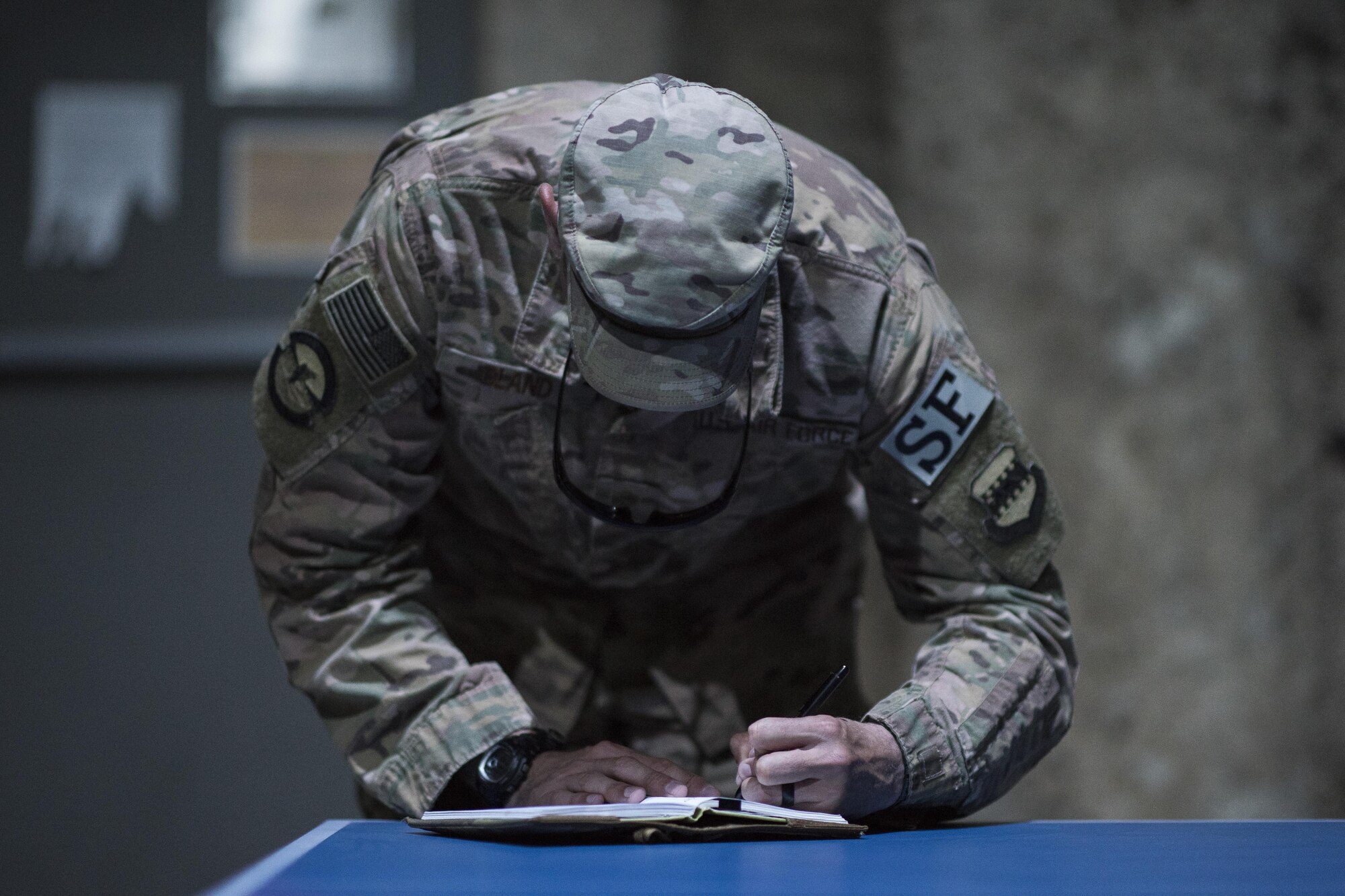 Master Sgt. Larry Bland, 332nd Expeditionary Security Forces Squadron flight chief, writes down notes during an active shooter exercise June 8, 2017, in Southwest Asia. Bland evaluated a security forces team as they cleared a building and secured the area for medical personal. (U.S. Air Force photo/Senior Airman Damon Kasberg)