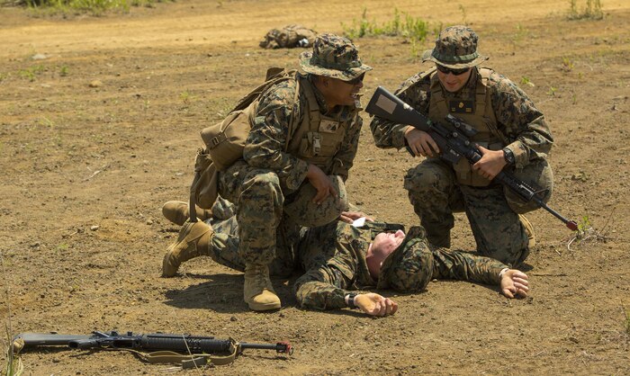 U.S. Marine Corps Sgt. Reiner Franz, left, and Sgt. Christopher Pietz, right, Marines with Marine Wing Support Squadron (MWSS) 171, based out of Marine Corps Air Station Iwakuni, provide medical assistance to a Marine during an unexpected mass casualty drill while participating in exercise Eagle Wrath 2017 at Combined Arms Training Center Camp Fuji, Japan, June 15, 2017. Franz is trained to be a combat life saver during medical emergencies and was one of the first responders during the drill. Eagle Wrath 2017 is a two-week training evolution focusing on air base ground defense and establishing a forward operating base in an austere environment. (U.S. Marine Corps photo by Lance Cpl. Stephen Campbell)