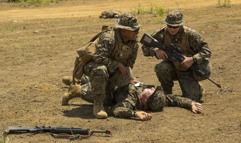 U.S. Marine Corps Sgt. Reiner Franz, left, and Sgt. Christopher Pietz, right, Marines with Marine Wing Support Squadron (MWSS) 171, based out of Marine Corps Air Station Iwakuni, provide medical assistance to a Marine during an unexpected mass casualty drill while participating in exercise Eagle Wrath 2017 at Combined Arms Training Center Camp Fuji, Japan, June 15, 2017. Franz is trained to be a combat life saver during medical emergencies and was one of the first responders during the drill. Eagle Wrath 2017 is a two-week training evolution focusing on air base ground defense and establishing a forward operating base in an austere environment. (U.S. Marine Corps photo by Lance Cpl. Stephen Campbell)
