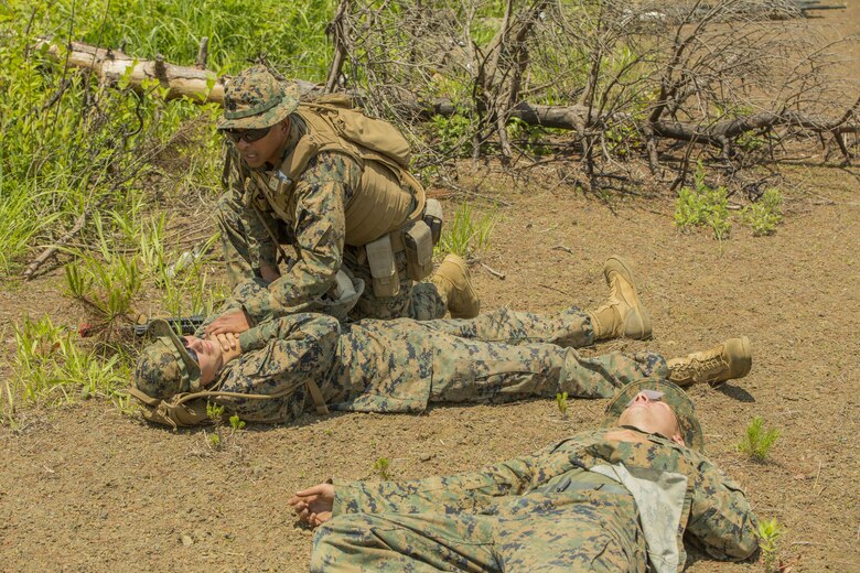 U.S. Marine Corps Sgt. Reiner Franz, a Marine with Marine Wing Support Squadron (MWSS) 171, based out of Marine Corps Air Station Iwakuni, provides medical assistance to injured Marines during an unexpected mass casualty drill while participating in exercise Eagle Wrath 2017 at Combined Arms Training Center Camp Fuji, Japan, June 15, 2017. Franz is trained to be a combat life saver during medical emergencies and was one of the first responders during the drill. Eagle Wrath 2017 is a two-week training evolution focusing on air base ground defense and establishing a forward operating base in an austere environment. (U.S. Marine Corps photo by Lance Cpl. Stephen Campbell)