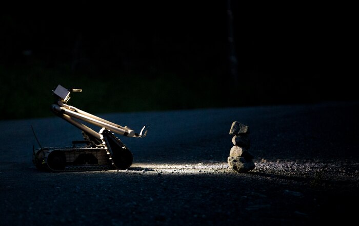 A PackBot, an unmanned explosive ordnance disposal robotic platform, controlled by a Marine EOD technician with Marine Wing Support Squadron (MWSS) 171, based out of Marine Corps Air Station Iwakuni, investigates a potential improvised explosive device during exercise Eagle Wrath 2017 at Combined Arms Training Center Camp Fuji, Japan, June 16, 2017. Eagle Wrath 2017 is a two-week training evolution focusing on air base ground defense, establishing forward operating bases and forward arming and refueling points in an austere environment as a way to support Marine Aircraft Group 12. (U.S. Marine Corps photo by Lance Cpl. Stephen Campbell)