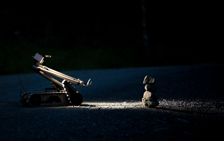 A PackBot, an unmanned explosive ordnance disposal robotic platform, controlled by a Marine EOD technician with Marine Wing Support Squadron (MWSS) 171, based out of Marine Corps Air Station Iwakuni, investigates a potential improvised explosive device during exercise Eagle Wrath 2017 at Combined Arms Training Center Camp Fuji, Japan, June 16, 2017. Eagle Wrath 2017 is a two-week training evolution focusing on air base ground defense, establishing forward operating bases and forward arming and refueling points in an austere environment as a way to support Marine Aircraft Group 12. (U.S. Marine Corps photo by Lance Cpl. Stephen Campbell)