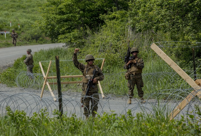 U.S. Marines assigned to Marine Wing Support Squadron (MWSS) 171, based out of Marine Corps Air Station Iwakuni, give hand signals to one another during a security patrol while participating in exercise Eagle Wrath 2017 at Combined Arms Training Center Camp Fuji, Japan. Eagle Wrath 2017 is a two-week training evolution focusing on air base ground defense, establishing forward operating bases and forward arming and refueling points in an austere environment as a way to support Marine Aircraft Group 12. (U.S. Marine Corps photo by Lance Cpl. Stephen Campbell)