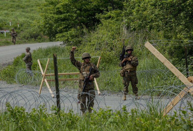 U.S. Marines assigned to Marine Wing Support Squadron (MWSS) 171, based out of Marine Corps Air Station Iwakuni, give hand signals to one another during a security patrol while participating in exercise Eagle Wrath 2017 at Combined Arms Training Center Camp Fuji, Japan. Eagle Wrath 2017 is a two-week training evolution focusing on air base ground defense, establishing forward operating bases and forward arming and refueling points in an austere environment as a way to support Marine Aircraft Group 12. (U.S. Marine Corps photo by Lance Cpl. Stephen Campbell)