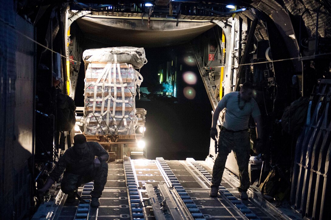 Air Force MC-130 Hercules aircraft crew chiefs prepare cargo and supplies for an airdrop over Syria, June 22, 2017. Air Force photo by Master Sgt. Jason Robertson
