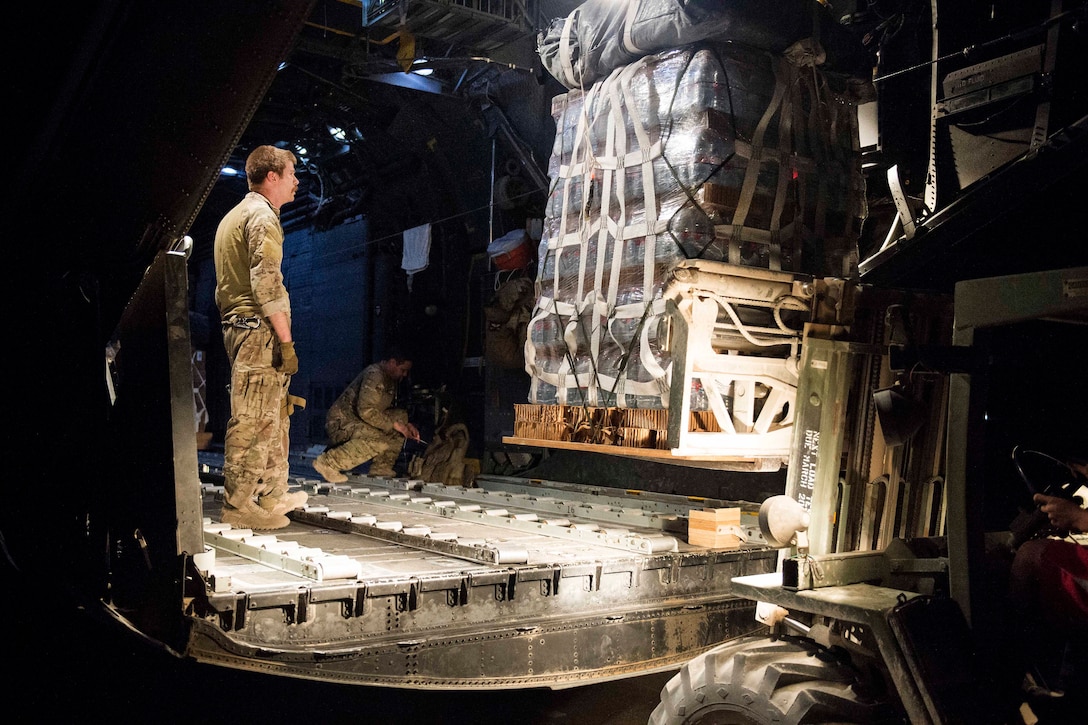 An Air Force airman loads a pallet of supplies onto an MC-130 Hercules aircraft before conducting an airdrop over Syria, June 22, 2017. Air Force photo by Master Sgt. Jason Robertson