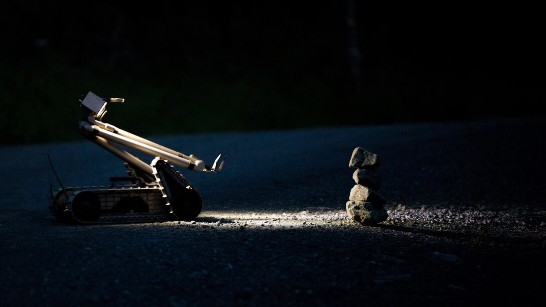 A PackBot, an unmanned explosive ordnance disposal robotic platform, controlled by a Marine EOD technician with Marine Wing Support Squadron (MWSS) 171, based out of Marine Corps Air Station Iwakuni, investigates a potential improvised explosive device during exercise Eagle Wrath 2017 at Combined Arms Training Center Camp Fuji, Japan, June 16, 2017. Eagle Wrath 2017 is a two-week training evolution focusing on air base ground defense, establishing forward operating bases and forward arming and refueling points in an austere environment as a way to support Marine Aircraft Group 12. (U.S. Marine Corps photo by Lance Cpl. Stephen Campbell)
