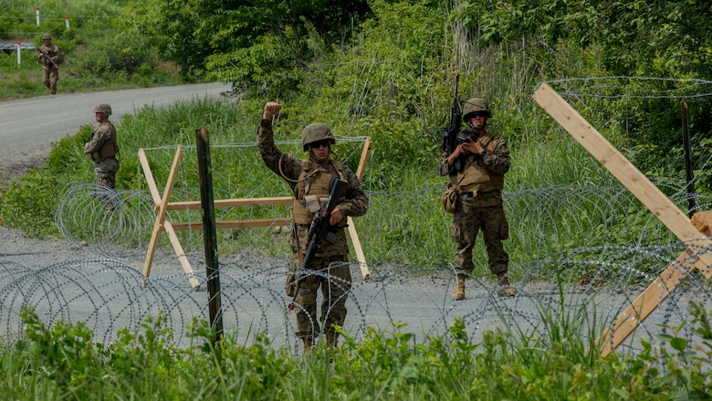 U.S. Marines assigned to Marine Wing Support Squadron (MWSS) 171, based out of Marine Corps Air Station Iwakuni, give hand signals to one another during a security patrol while participating in exercise Eagle Wrath 2017 at Combined Arms Training Center Camp Fuji, Japan. Eagle Wrath 2017 is a two-week training evolution focusing on air base ground defense, establishing forward operating bases and forward arming and refueling points in an austere environment as a way to support Marine Aircraft Group 12. (U.S. Marine Corps photo by Lance Cpl. Stephen Campbell)