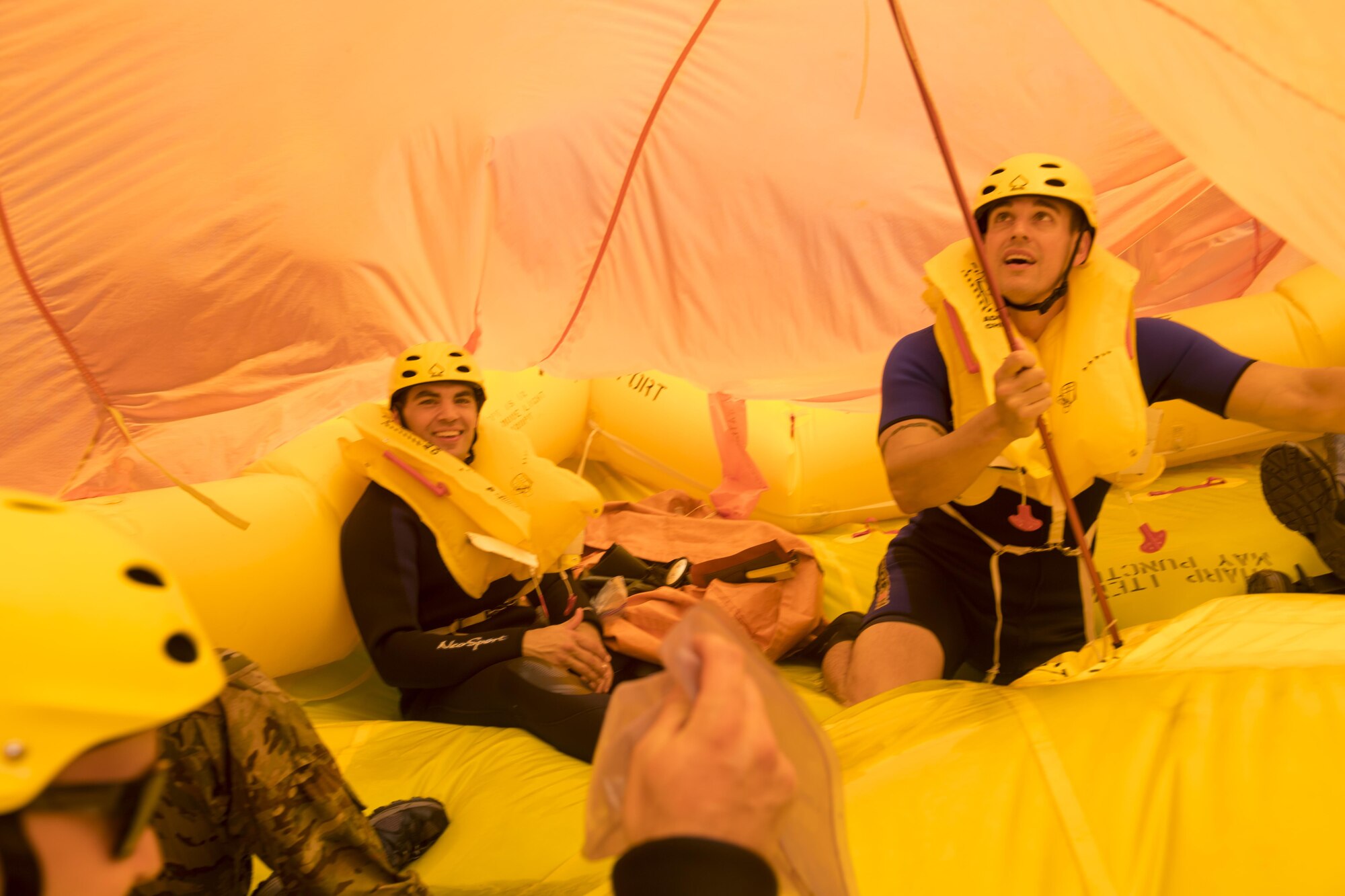 Water survival training students work to erect a tarp cover for their raft in Barnegat, N.J. June 22. The students received classroom instruction then a hands on portion that included swimming strokes, emergency procedures and rescue from a U.S. Coast Guard helicopter. (U.S. Air Force photo by Senior Airman Joshua King)