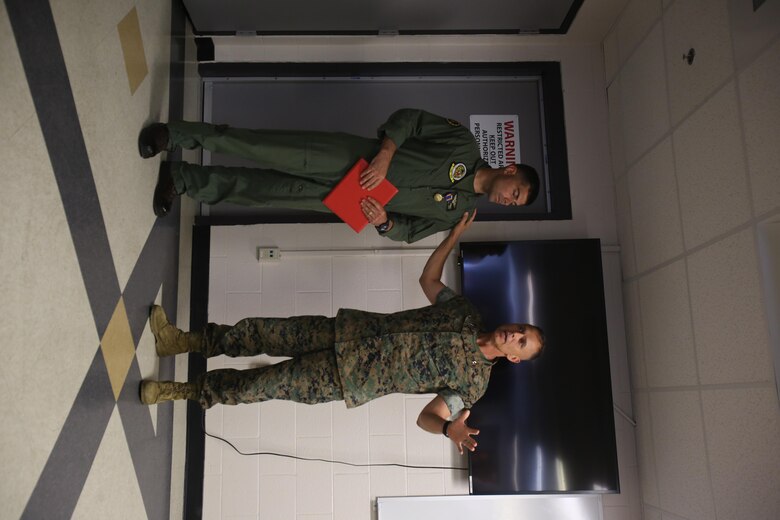 Maj. Gen. Matthew Glavy (right) speaks about Capt. Craig Nygaard after awarding Nygaard the Air Medal at Marine Corps Air Station Cherry Point, N.C.,  June 26, 2017. Nygaard was awarded this medal for operations conducted during Operation Inherent Resolve while assigned to Marine Attack Squadron 231, Marine Aircraft Group 14, 2nd Marine Aircraft Wing. While forward deployed, Nygaard volunteered to return home early in order to deploy with a detachment from Marine Attack Squadron 542, MAG -14, 2nd MAW in support of the 26th Marine Expeditionary Unit’s mission. Glavy is the commanding general of 2nd MAW. Nygaard is an AV-8B Harrier pilot assigned to VMA-542. (U.S. Marine Corps Photo by Pfc. Skyler Pumphret/ Released)