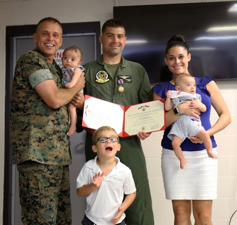 Major Gen. Matthew Glavy (left) poses with Capt. Craig Nygaard and his family at Marine Corps Air Station Cherry Point, N.C., June 26, 2017. Nygaard was awarded the Air Medal for operations conducted during Operation Inherent Resolve while assigned to Marine Attack Squadron 231, Marine Aircraft Group 14, 2nd Marine Aircraft Wing. While forward deployed, Nygaard volunteered to return home early in order to deploy with a detachment from Marine Attack Squadron 542, MAG -14, 2nd MAW in support of the 26th Marine Expeditionary Unit’s mission. Glavy is the commanding general of 2nd MAW. Nygaard is an AV-8B Harrier pilot assigned to VMA-542. (U.S. Marine Corps Photo by Pfc. Skyler Pumphret/ Released) 