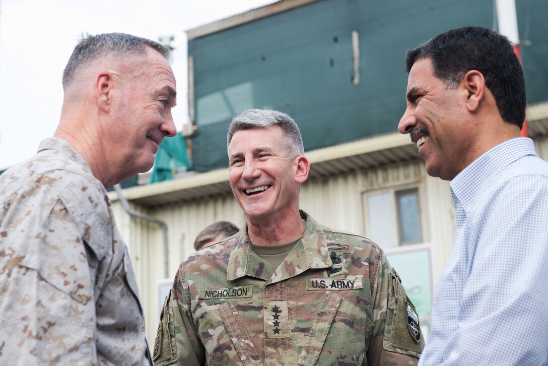 Marine Corps Gen. Joe Dunford, chairman of the Joint Chiefs of Staff, speaks with Army Gen. John W. Nicholson, Resolute Support commander, and an Afghan advisor in Kabul, Afghanistan, June 26, 2017. Dunford traveled throughout the country meeting with U.S., coalition and Afghan leaders. DoD photo by Army Sgt. James K. McCann
