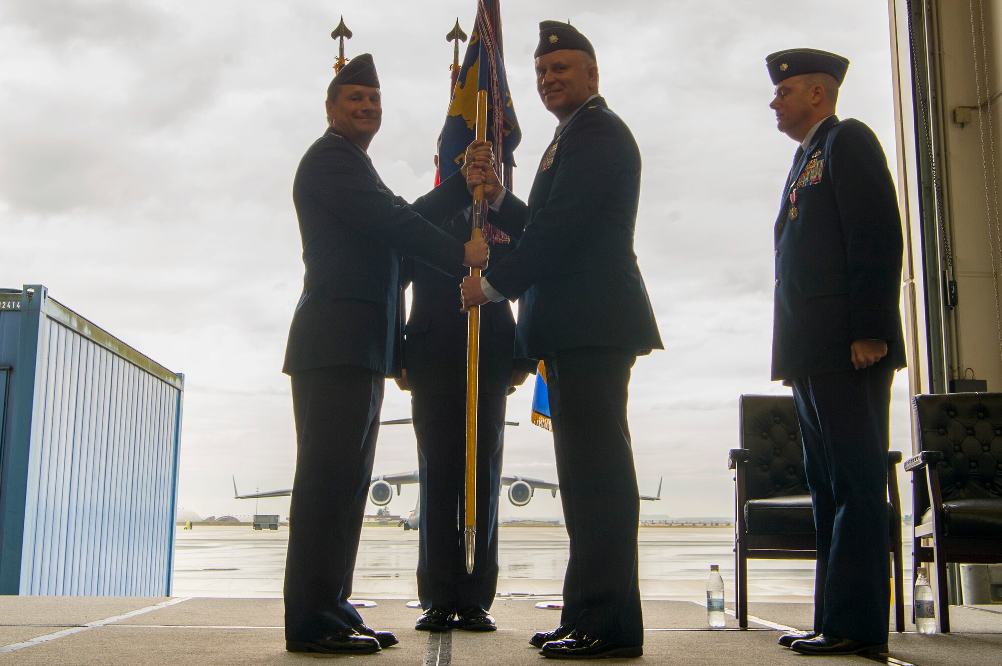 U.S. Air Force Col. Ryan Marshall, 721st Air Mobility Operations Group commander, left, gives the ceremonial guidon to U.S. Air Force Lt. Col. Shannon Caleb incoming 726th Air Mobility Squadron commander, during the 726th AMS change of command ceremony on Spangdahlem Air Base, Germany, June 27, 2017. (U.S. Air Force photo by Senior Airman Dawn Weber)