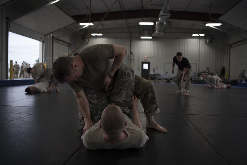 U.S. Army Reserve military police Soldiers with the 300th Military Police Brigade practice combatives during Guardian Justice at Fort McCoy, Wisconsin, June 22. Guardian Justice is a functional exercise, broken down into two-week cycles, centered on squad and team-level training with a focus on internment, resettlement, detainee operations and combat support. During each two-week cycle, Soldiers train on internment operations, weapons qualification, biometrics, reflexive fire, Military Operations on Urbanized Terrain (MOUT), non-lethal Tasers, MP battle drills and include a situational training exercise. (U.S. Army Reserve photo by Sgt. Audrey Hayes)