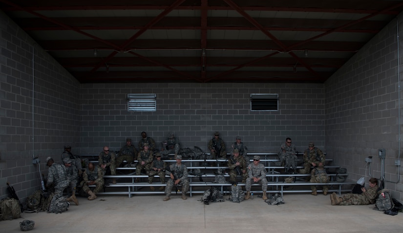 U.S. Army Reserve Soldiers with the with the 300th Military Police Brigade, out of Inkster, Michigan, rest after M4 reflexive fire training during Guardian Justice at Fort McCoy, Wisconsin., June 23. Guardian Justice is a functional exercise, broken down into two-week cycles, centered on squad and team-level training with a focus on internment, resettlement, detainee operations and combat support. During each two-week cycle, Soldiers train on internment operations, weapons qualification, biometrics, reflexive fire, Military Operations on Urbanized Terrain (MOUT), non-lethal Tasers, MP battle drills and situational training exercises. (U.S. Army Reserve photo by Sgt. Audrey Hayes)