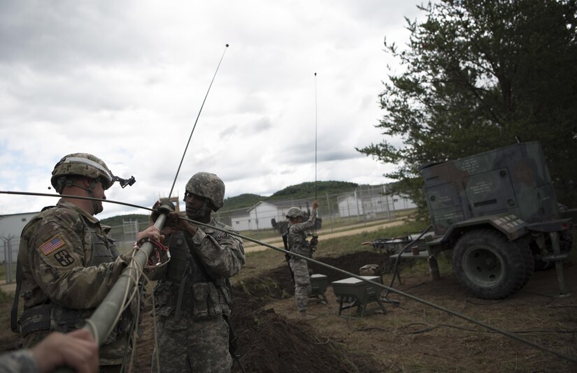 U.S. Army Reserve military police Soldiers with the 300th MP Brigade set up an OE-254 during Guardian Justice at Fort McCoy, Wisconsin, June 24. Guardian Justice is a functional exercise, broken down into two-week cycles, centered on squad and team-level training with a focus on internment, resettlement, detainee operations and combat support. During each two-week cycle, Soldiers train on internment operations, weapons qualification, biometrics, reflexive fire, Military Operations on Urbanized Terrain (MOUT), non-lethal Tasers, MP battle drills and include a situational training exercise. (U.S. Army Reserve photo by Sgt. Audrey Hayes)