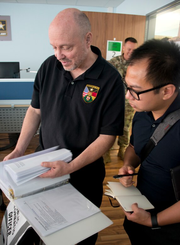 Capt. Jeku Arce (right), 221st Public Affairs Detachment Commander, goes over the public affairs tasks during an active shooter scenario with Stefan Alford, Director of Public Affairs at U.S. Army Garrison Rhineland-Pfalz, during Warrior Response 17 on June 24 in Kaiserslautern, Germany (U.S. Army photo by Richard Bumgardner).