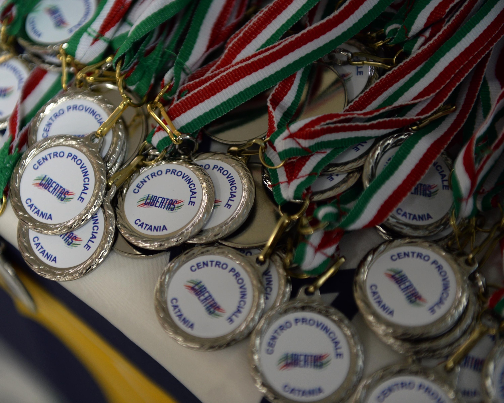 Medals lay on a table during a Special Olympics event award ceremony in Cantania, Sicily, June 7, 2017. The event was planned by Airmen deployed to the 324th Expeditionary Reconnaissance Squadron and had more than 60 children participate. (U.S. Air Force photo by Senior Airman Jimmie D. Pike)