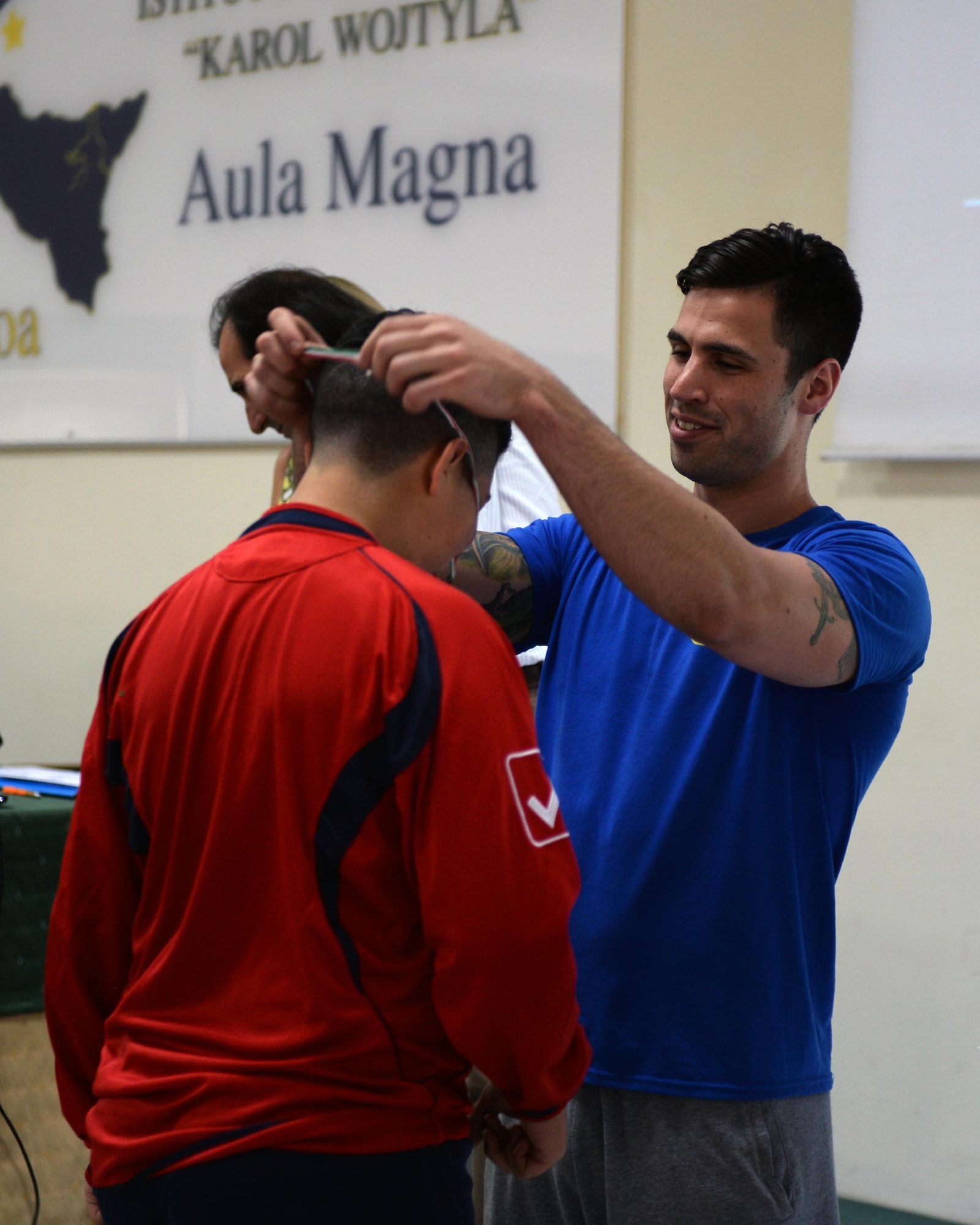 Senior Airman Tyler Horn, 324th Expeditionary Reconnaissance Squadron MQ-9 sensor operator, presents a medal to a Special Olympics participant in Cantania, Sicily, June 7, 2017. More than 60 children participated in the Special Olympics event that was coordinated by the 324th ERS Airmen. (U.S. Air Force photo by Senior Airman Jimmie D. Pike)