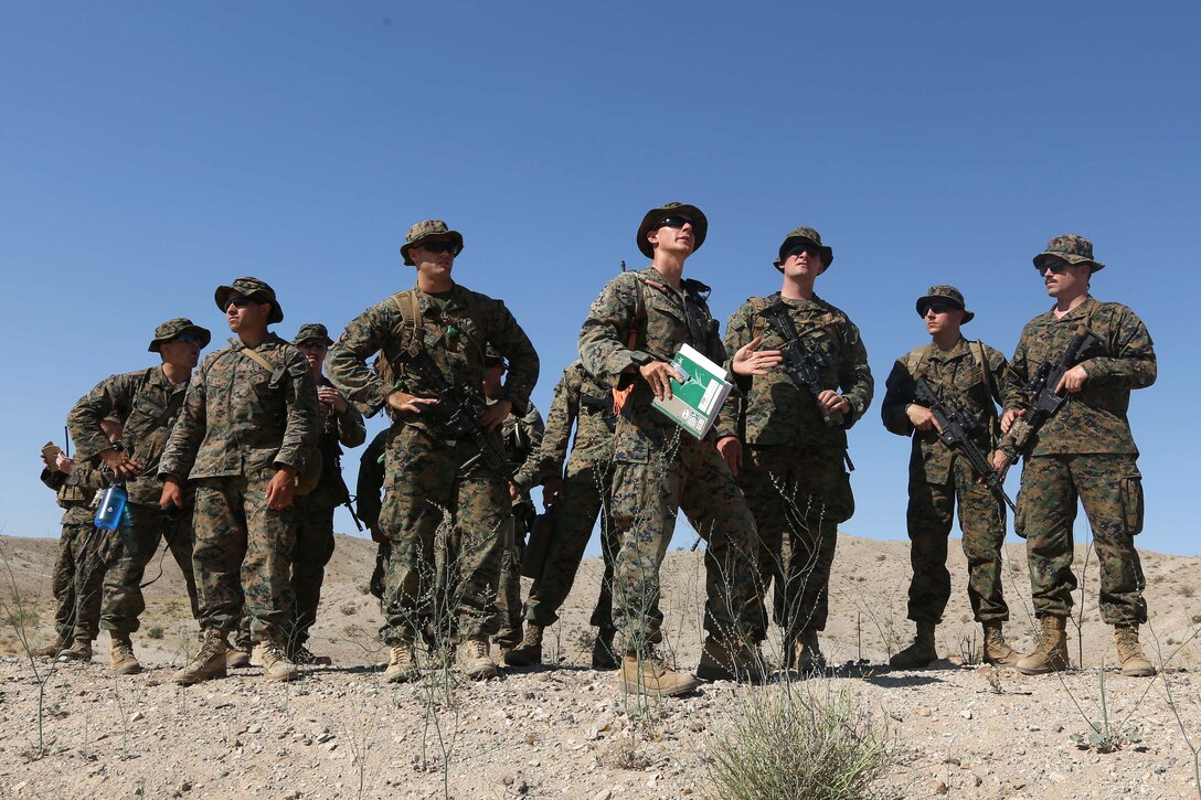 Marine Corps Reserve Maj. Nathaniel Piccard, center, discusses notional objectives and targets during an air assault course as part of the final battalion exercise of Integrated Training Exercise 4-17 at Camp Wilson, Marine Air Ground Combat Center, Twentynine Palms, Calif., June 21, 2017. Piccard is the commander of Golf Company, 2nd Battalion, 25th Marines, 4th Marine Division, Marine Forces Reserve. Marine Corps photo by Lance Cpl. Stanley Moy