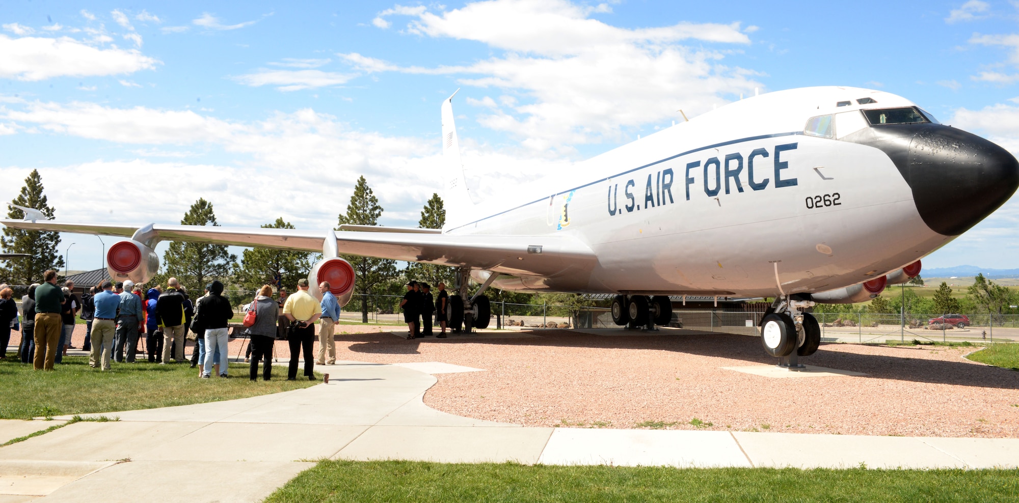 Members of the 4th Airborne Command Control Squadron attend a memorial dedication during the 25th anniversary of the deactivation of the 4th ACCS at the South Dakota Air and Space Museum, Box Elder, S.D., June 24, 2017. A bench displaying images of the EC-135 was dedicated to those who served in the squadron and have passed away. The bench sits on the museum grounds under tail 262, nicknamed “Too Sick to Fly.” (U.S. Air Force photo by Staff Sgt. Hailey Staker)