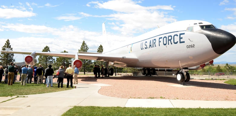 Members of the 4th Airborne Command Control Squadron attend a memorial dedication during the 25th anniversary of the deactivation of the 4th ACCS at the South Dakota Air and Space Museum, Box Elder, S.D., June 24, 2017. A bench displaying images of the EC-135 was dedicated to those who served in the squadron and have passed away. The bench sits on the museum grounds under tail 262, nicknamed “Too Sick to Fly.” (U.S. Air Force photo by Staff Sgt. Hailey Staker)