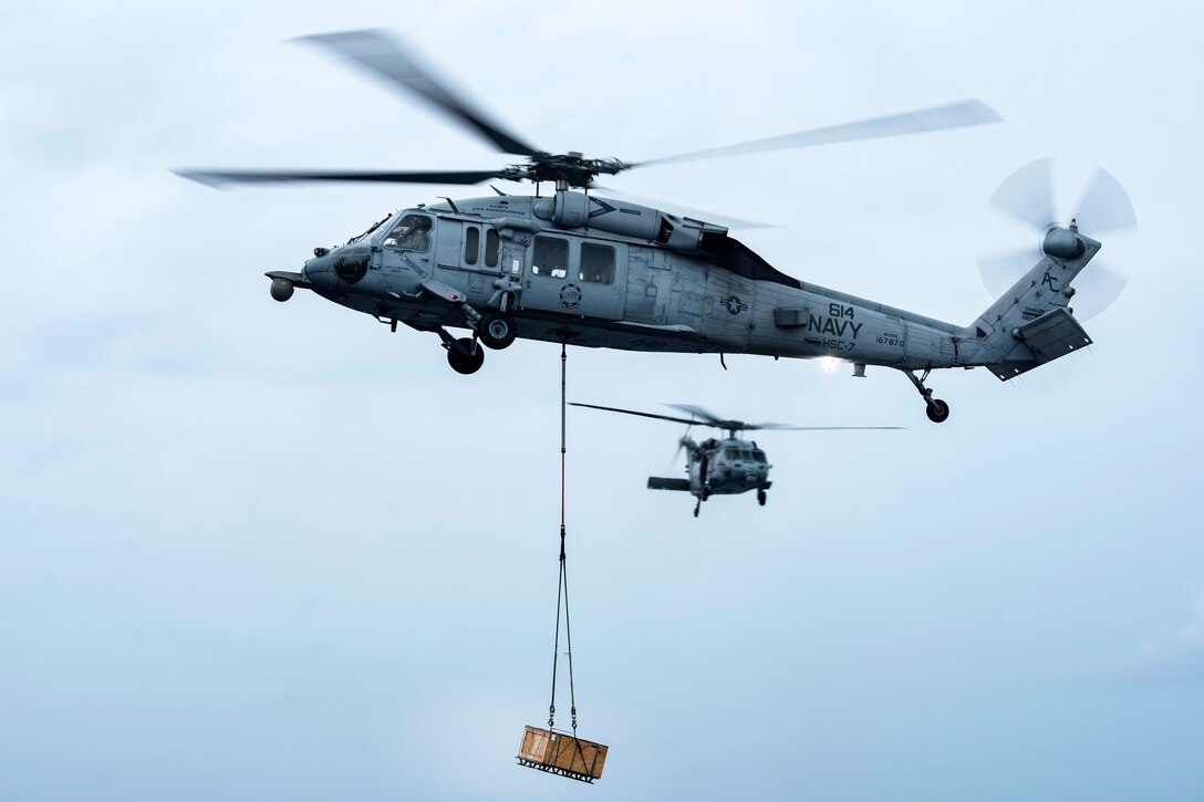 A Navy MH-60S Sea Hawk helicopter delivers ammunition crates to the dry cargo and ammunition ship USNS Medgar Evers during an ammunition offload with the aircraft carrier USS Dwight D. Eisenhower in the Atlantic Ocean, June 21, 2017. Navy photo by Petty Officer 3rd Class Nathan T. Beard