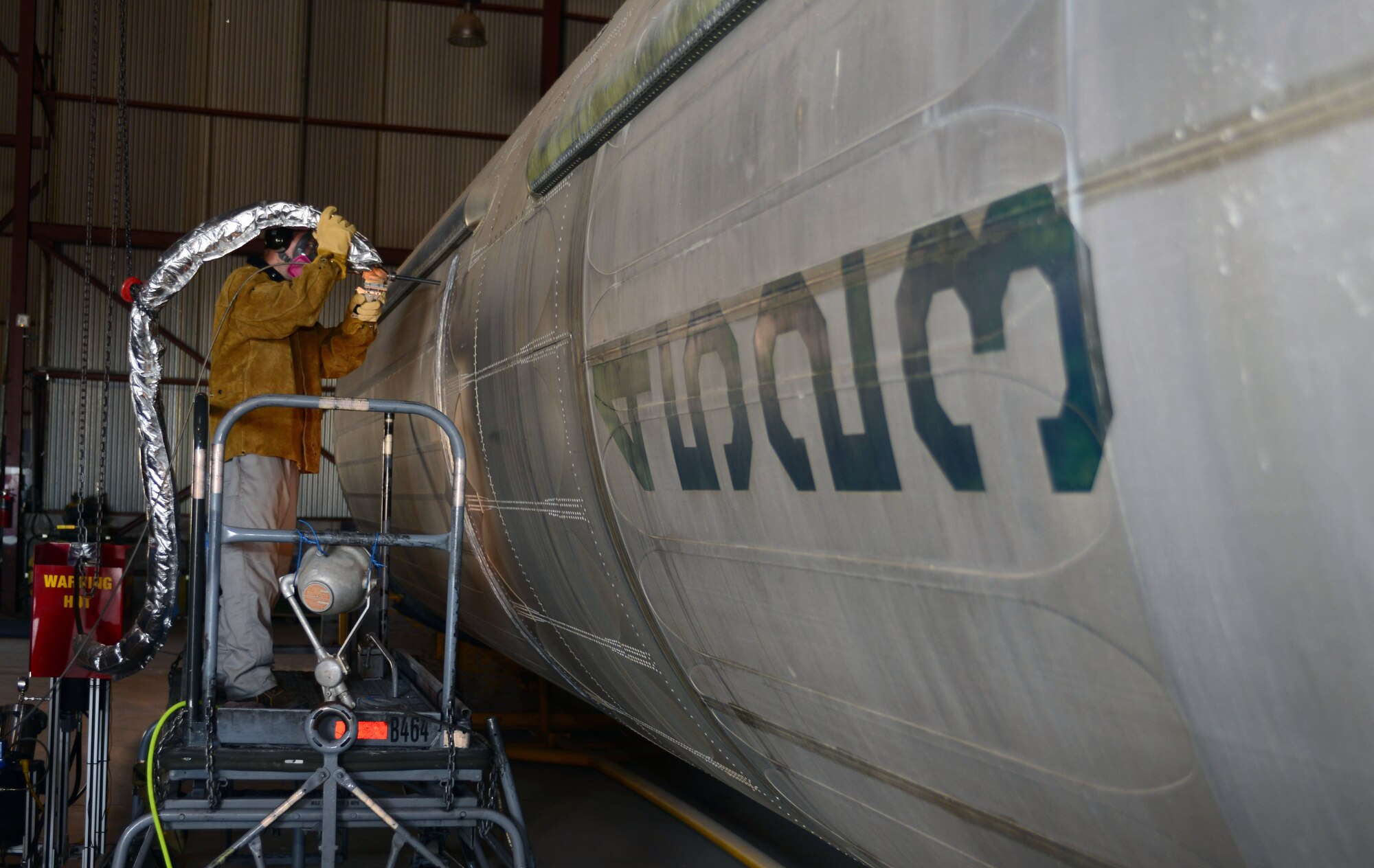Dustin Blosmo, the chief engineer with VRC Metal Systems, repairs the side of a Martin Marietta HGM-25A Titan I with a mobile Cold Spray machine in Dock 43 at Ellsworth Air Force Base, S.D., June 22, 2017. Cold Spray is a technology that accelerates small particles of the substrate [whatever the material is made out of] to achieve a mechanical bond upon impact restoring the part back to the original specifications. (U.S. Air Force photo by Airman 1st Class Donald C. Knechtel)