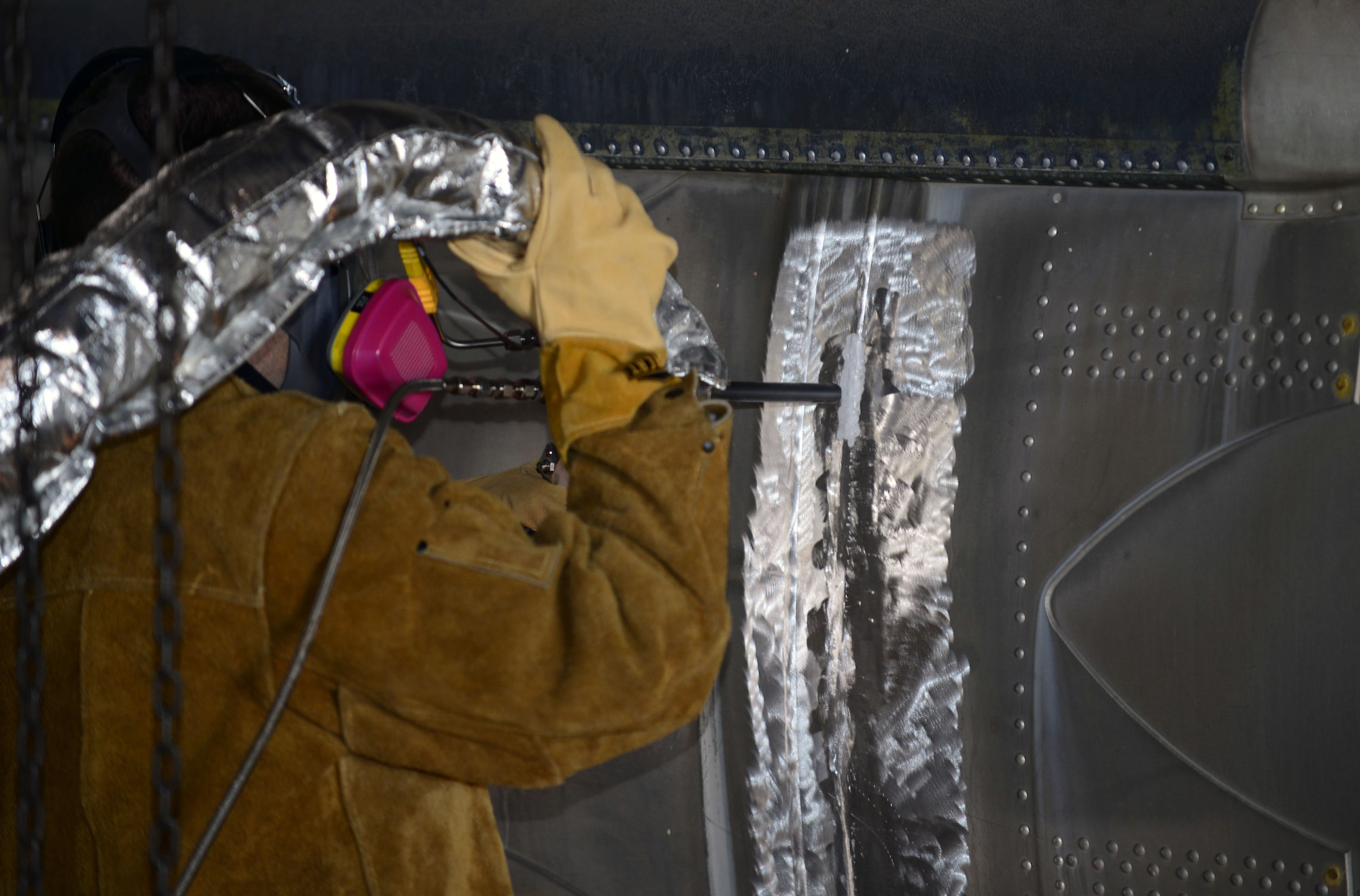 Dustin Blosmo, the chief engineer with VRC Metal Systems, repairs the side of a Martin Marietta HGM-25A Titan I with a mobile Cold Spray machine in Dock 43 at Ellsworth Air Force Base, S.D., June 22, 2017. With this technology, maintainers are able to repair thinner metals that traditional welding would not be able to do, allowing them to restore previously unrepairable objects. (U.S. Air Force photo by Airman 1st Class Donald C. Knechtel)