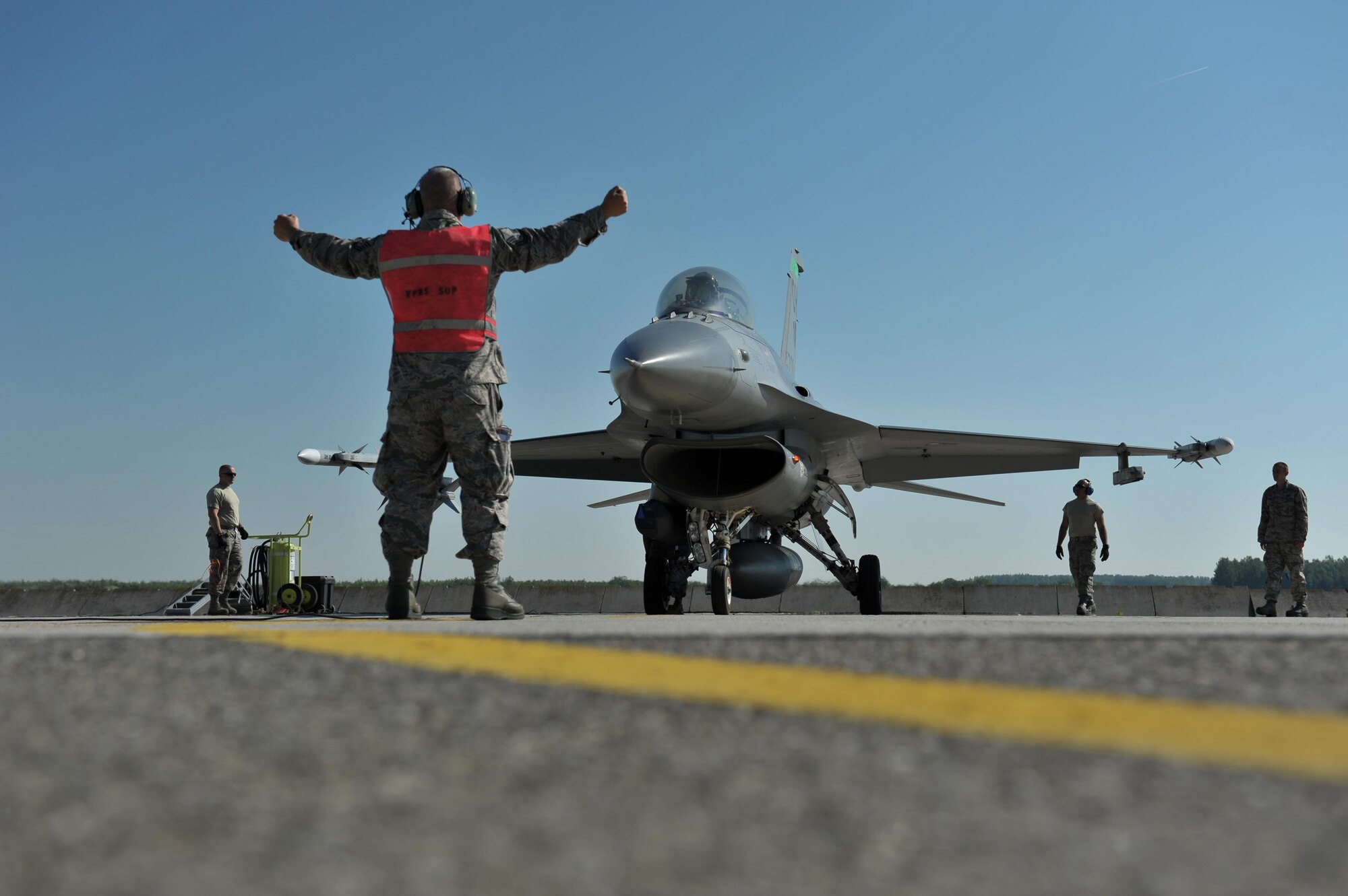 Master Sgt. Joe Ray, a weapons loader assigned to the 180th Fighter Wing, monitors a final preflight safety check on an F-16 Fighting Falcon, May 29, 2017 at Kecskemet Air Base in Hungary. Approximately 150 Airmen and eight F-16 fighter jets from the 180FW traveled to the air base to participate in Load Diffuser 17, a two-week Hungarian-led multinational exercise focused on enhancing interoperability capabilities and skills among NATO allied and European partner air forces by conducting joint operations and air defenses to maintain joint readiness, while also bolstering relationships within the U.S. Air National Guard’s State Partnership Program initiatives. Ohio became state partners with Hungary in 1993. Air National Guard photo by Senior Master Sgt. Beth Holliker.