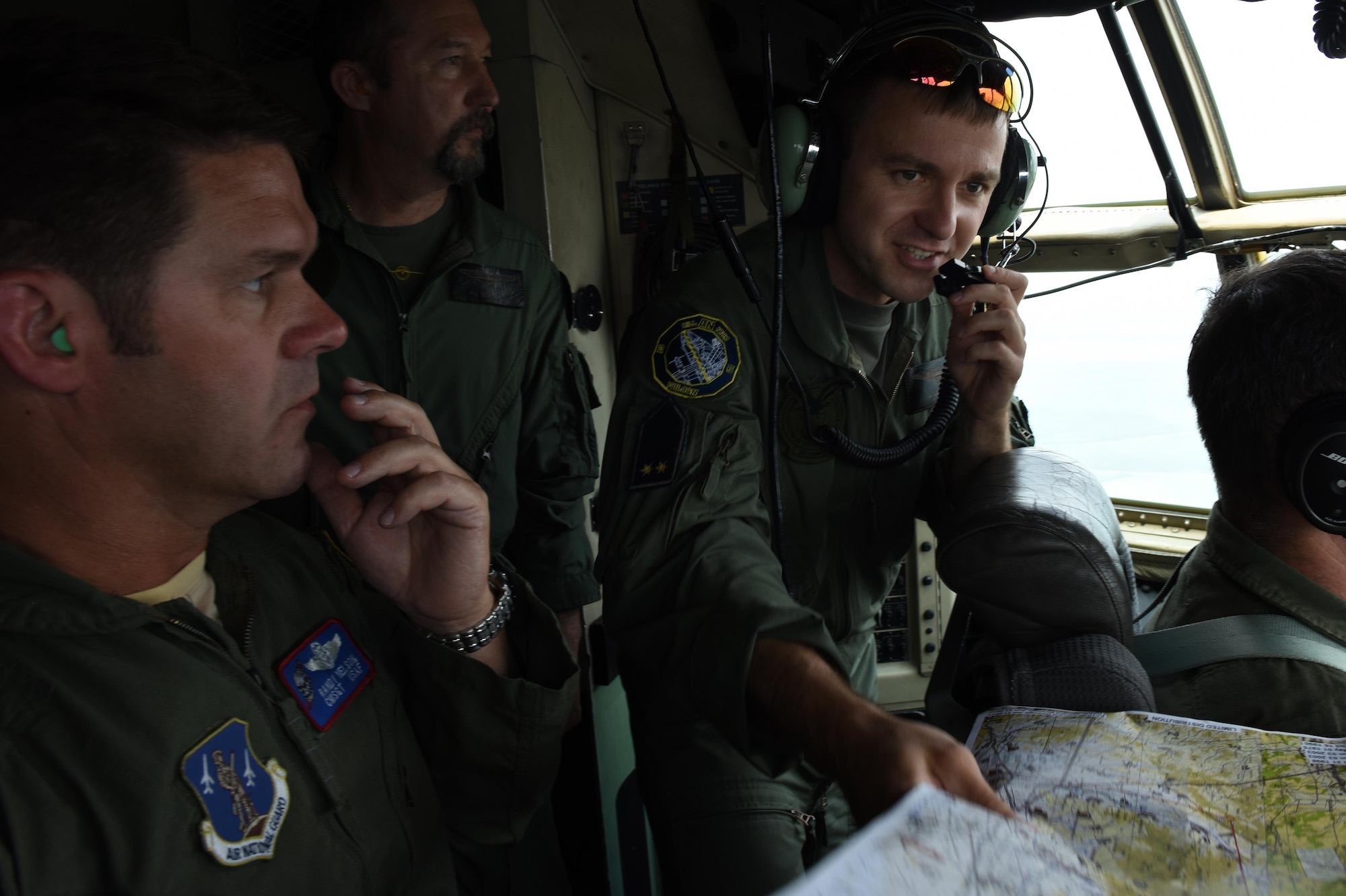 U.S. Air Force Chief Master Sgt. Randy Nelson (left), Hungarian Air Force Maj. Bela Torma (middle left), and Hungarian Air Force Lt. Lajos Halmi (right), both Hungarian AN-26 Antonov pilots, communicate with the two U.S. Air Force pilots during a C-130 flight, orienting them to the Ohio Air National Guard’s 179th Airlift Wing flying mission during Exercise Load Diffuser in Kecskemet, Hungary, on June 6. The exercise is the first Load Diffuser Exercise in Hungary in seven years and only the third of its kind in the two-decade State Partnership between Hungary and the Ohio National Guard.