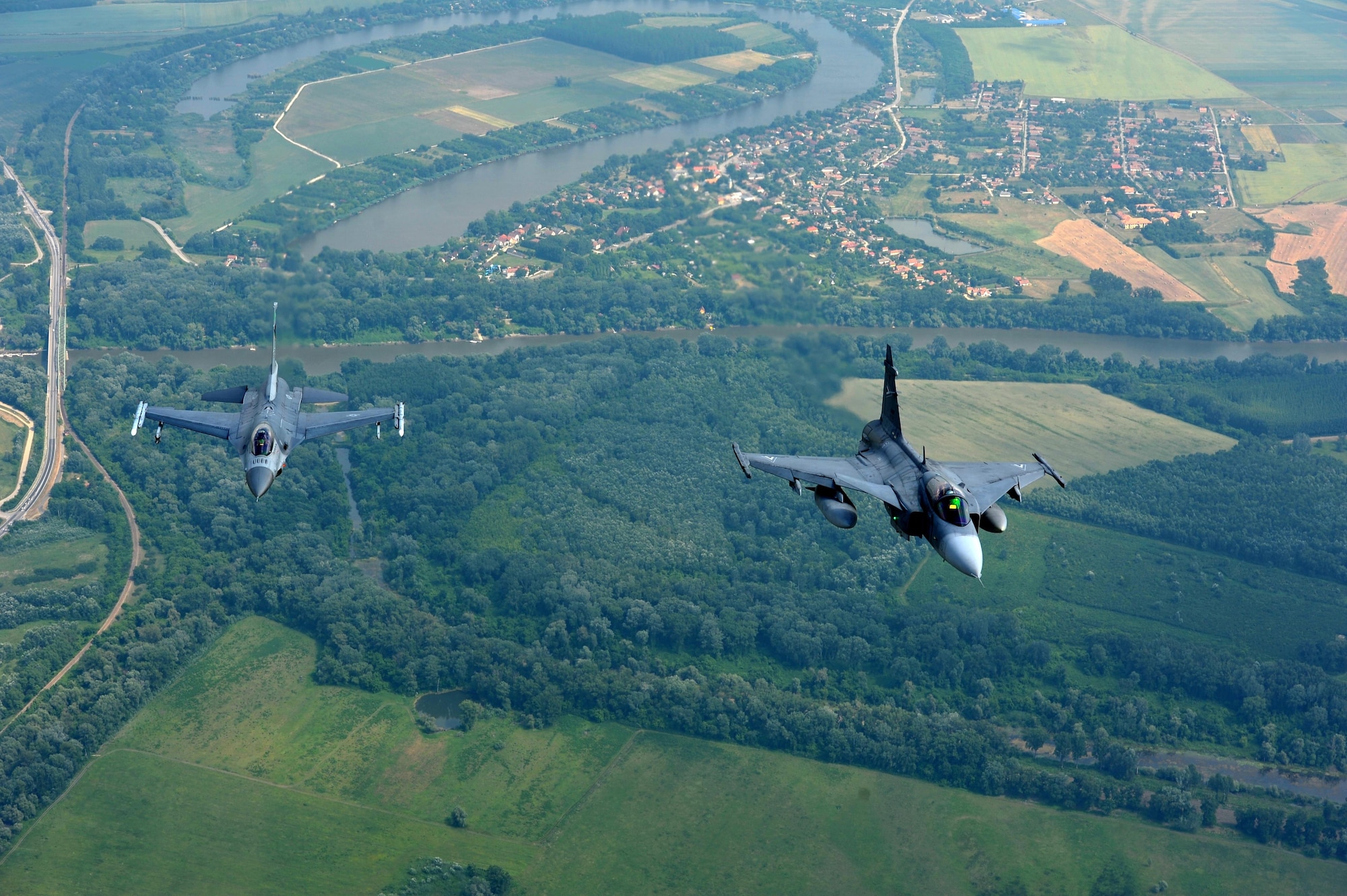 An F-16 Fighting Falcon assigned to the 180th Fighter Wing, Ohio Air National Guard, flies alongside a Hungarian JAS 39 Grippens during exercise Load Diffuser 17 at Kecskemet Air Base, Hungary, May 25, 2017. More than 150 Airmen from the 180FW and eight F-16s are participating in the Hungarian led, two week multinational exercise focused on enhancing interoperability capabilities and skills among NATO allied and European partner air forces by conducting joint operations and air defenses to maintain joint readiness, while also bolstering relationships within the U.S. Air National Guard’s State Partnership Program initiatives. Ohio became state partners with Hungary in 1993. Air National Guard photo by Senior Master Sgt. Beth Holliker.