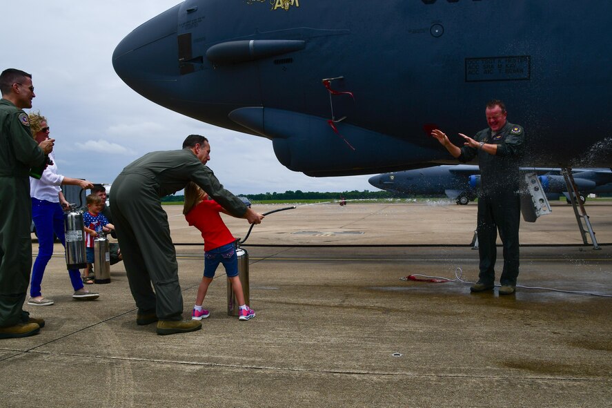 Col. Bruce R. Cox, commander of the 307th Bomb Wing, is greeted by sprays of water from his family and friends after landing from his final flight on Barksdale Air Force Base, La. June 24, 2017. Cox piloted the B-52 Stratofortress for the last time before he retires in July after more than 31 years of service. (U.S. Air Force photo by Master Sgt. Dachelle Melville/Released)