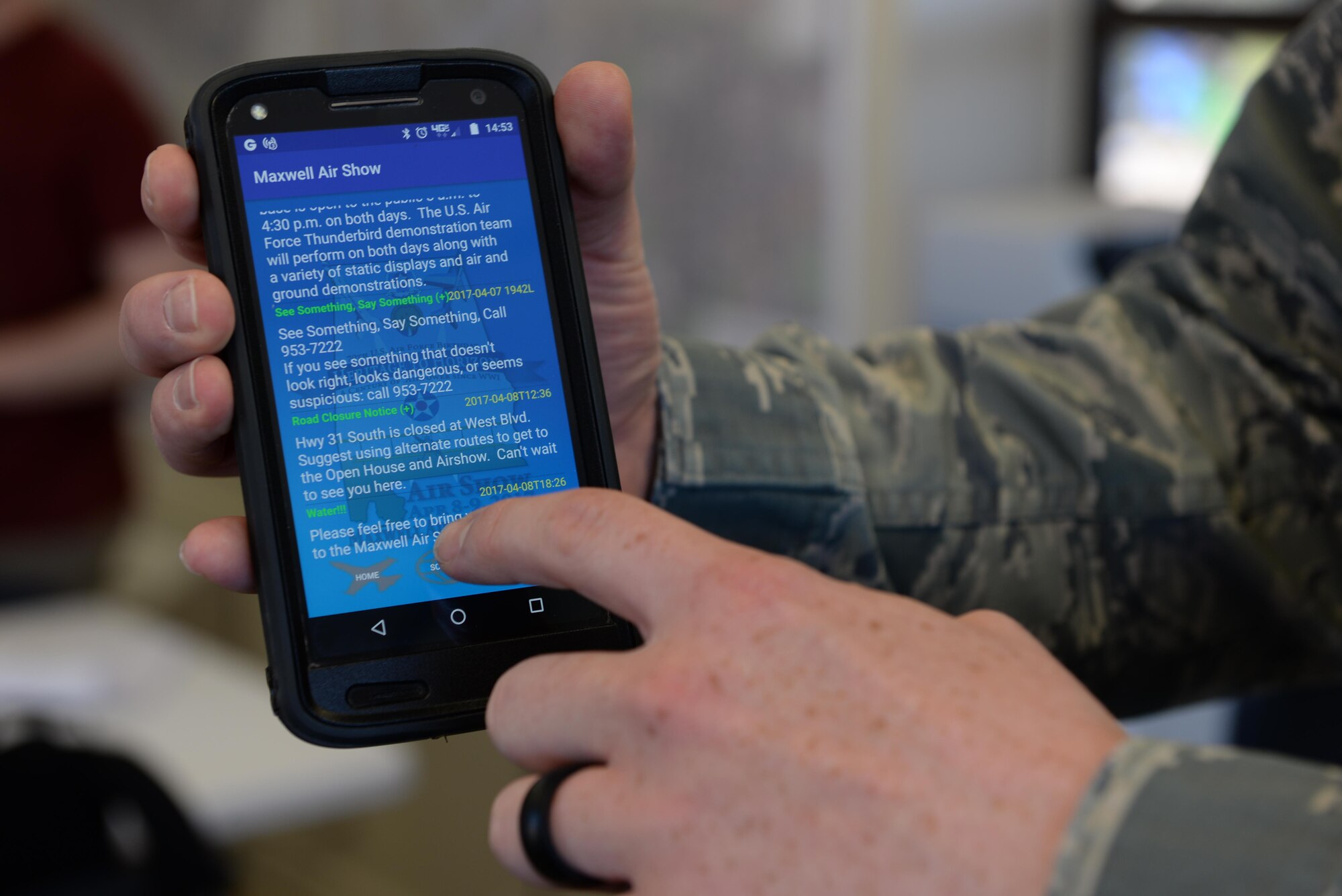 An Airman uses the Maxwell Airshow App, during the 2017 Maxwell Airshow on Maxwell Air Force Base, Ala., April 9, 2017. The app provided information about upcoming events and to lead participants to the various food and souvenier vendors. (U.S. Air Force photo/Senior Airman Tammie Ramsouer) 