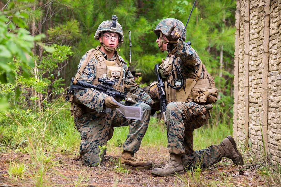 After studying a map, a Marine points in the direction of their follow-on objective during a combat readiness exercise at Camp Lejeune, N.C., June 21, 2017. Marine Corps photo by Cpl. Luke Hoogendam