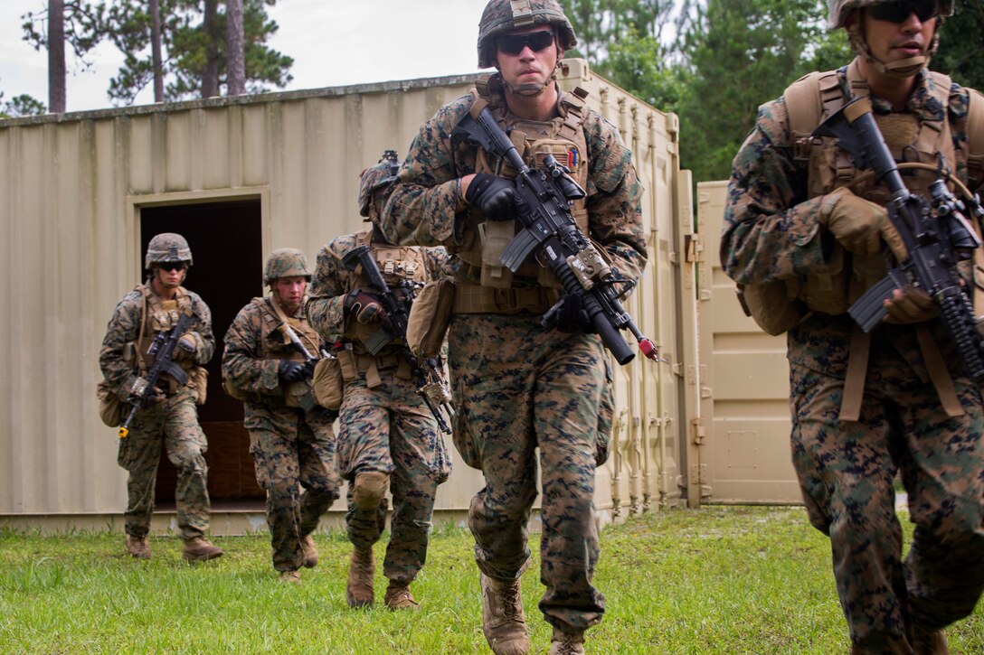 Marines rush to cover during an assault on a simulated enemy installation during a combat readiness exercise at Camp Lejeune, N.C., June 21, 2017. Marine Corps photo by Cpl. Luke Hoogendam