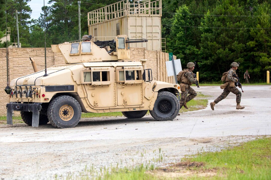 Marines rush forward during an assault on a simulated enemy installation at Camp Lejeune, N.C., June 21, 2017. Marine Corps photo by Cpl. Luke Hoogendam