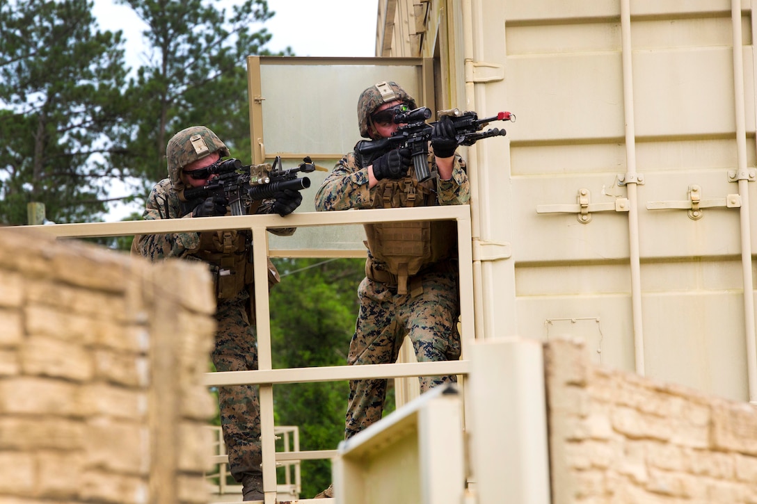 Marines fire to engage simulated enemy forces during an assault on a simulated enemy installation at Camp Lejeune, N.C., June 21, 2017. Marine Corps photo by Cpl. Luke Hoogendam