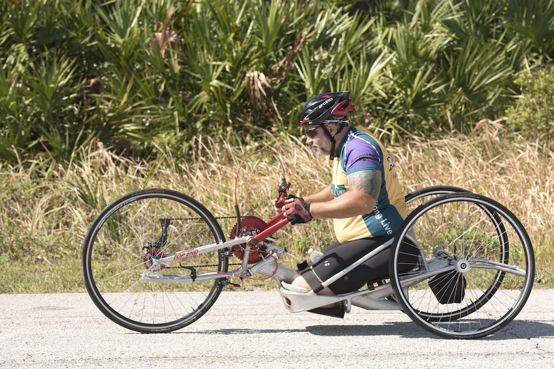 A service member rides a racing wheelchair during U.S. Special Operations Command’s training camp at MacDill Air Force Base, Fla., May 16, 2017. DoD photo by Roger L. Wollenberg
