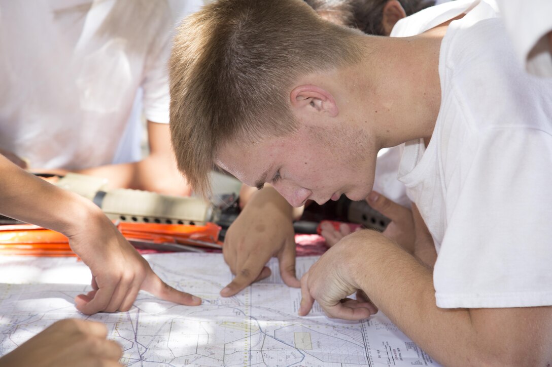 The Land Navigation class has students poring over a map to find a landmark designated by their instructor, June 13. SLAHD cadets also go on several conditioning hikes using compasses and maps to find their way.
