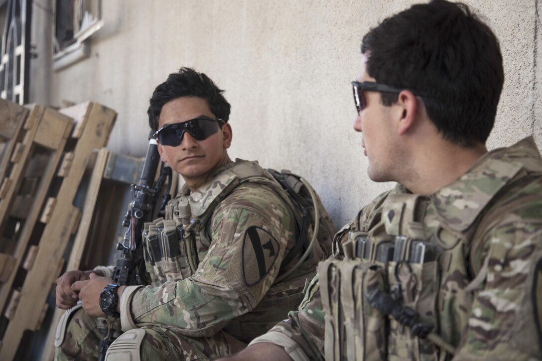 Army Sgt. Andrew Cervantes, left, and Spc. Robert Seelig rest after establishing a new patrol base alongside Iraqi forces in Mosul, Iraq, June 19, 2017. The soldiers are assigned to 1st Battalion, 12th Cavalry Regiment. Army photo by Cpl. Rachel Diehm