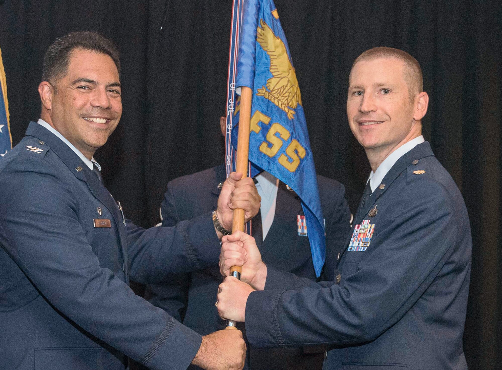 Maj. Jason Ware, right, accepts the 71st Force Support Squadron guidon from Col. Dwayne LaHaye, commander of 71st Mission Support Group, at the squadron’s change of command ceremony June 23, at Vance Air Force Base, Oklahoma. (U.S. Air Force photo/ Terry Wasson)