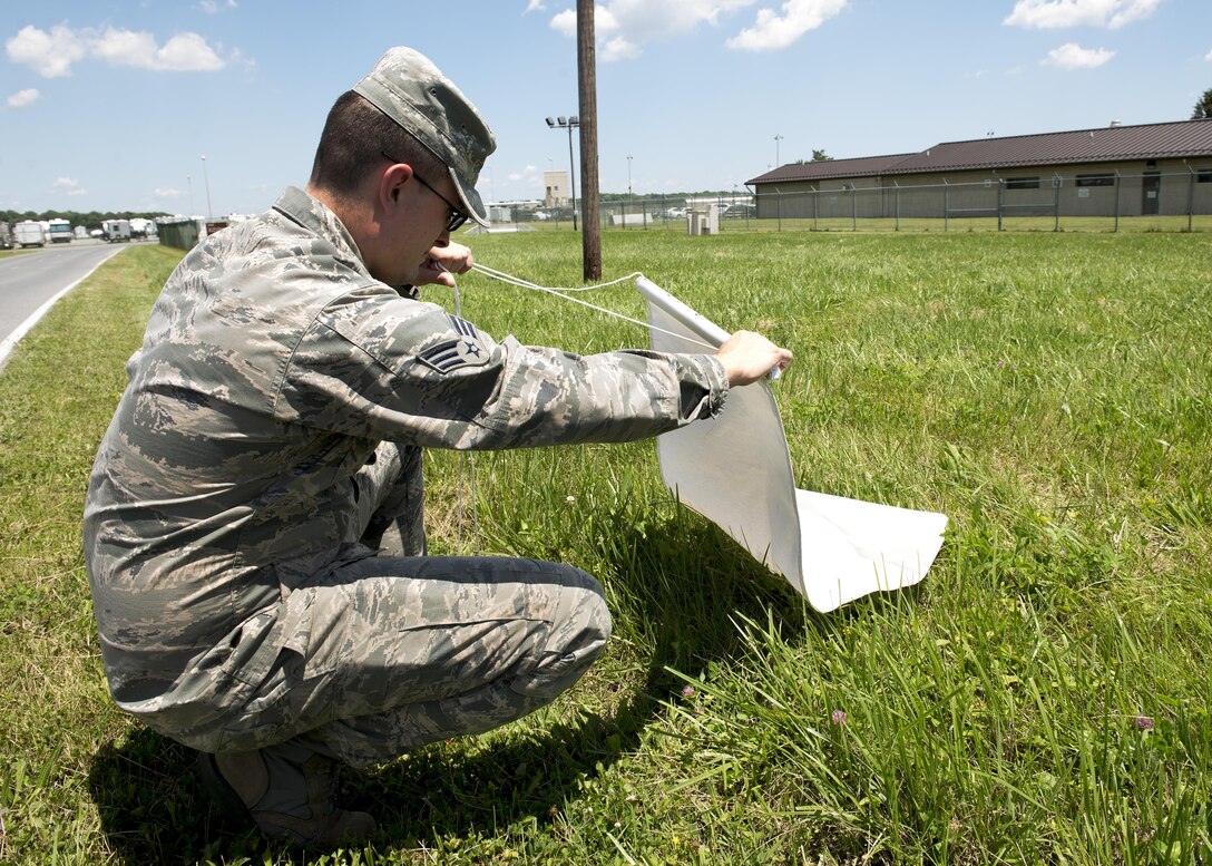 Senior Airman Moss Purcell, 436th Aerospace Medicine Squadron public health technician, checks a piece of white cloth for ticks June 9, 2017, at Dover Air Force Base, Del. Ticks that are caught are tested for diseases, including Lyme disease. (U.S. Air Force photo by Senior Airman Zachary Cacicia)