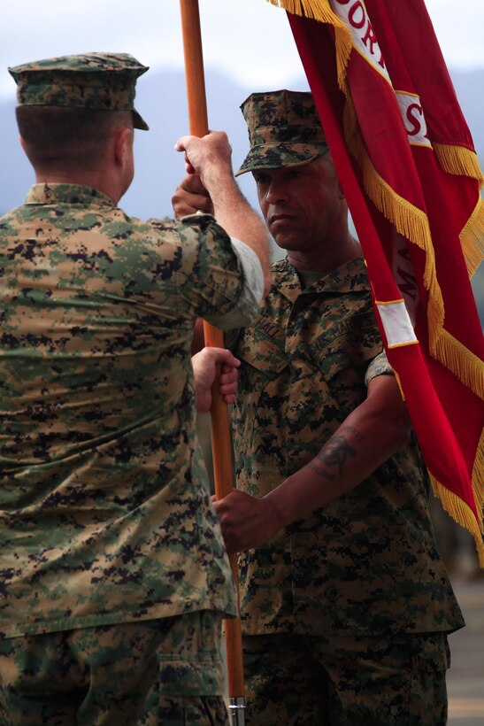MARINE CORPS BASE HAWAII – Sgt. Maj. Gregory L. Hall passes the Marine Corps flag to Col. Sean C. Killeen during a change of command ceremony aboard Marine Corps Air Station Kaneohe Bay on June 23, 2017. During the Ceremony, Killeen also retired from the Corps after 34 years of honorable service. (U.S. Marine Corps photo by Cpl. Alex Kouns/Released)