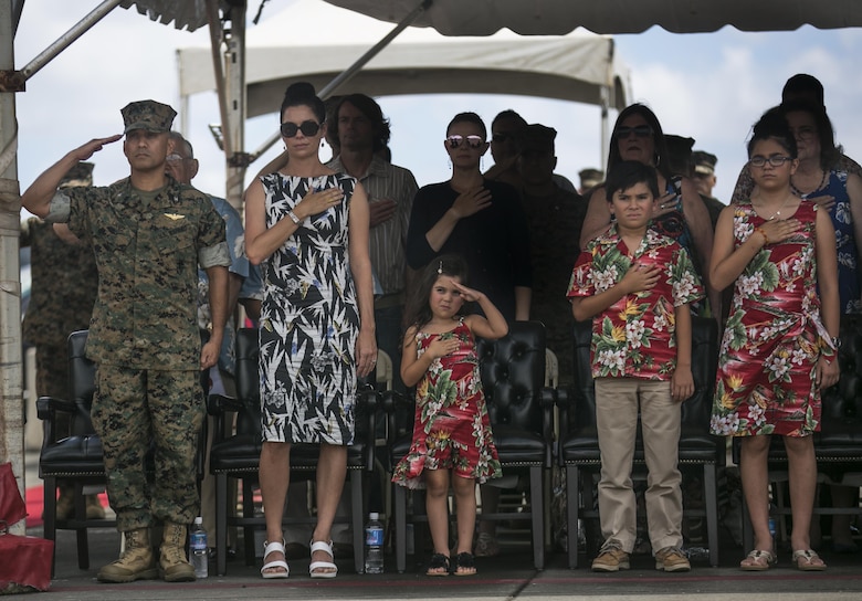 MARINE CORPS BASE HAWAII – Col. Raul Lianez and his family pay their respects while the national anthem is played during his change of command ceremony aboard Marine Corps Air Station Kaneohe Bay on June 23, 2017. During the ceremony, Col. Sean C. Killeen relinquished command of Marine Corps Base Hawaii to Lianez and Killeen retired from the Corps after 34 years of honorable service. (U.S. Marine Corps photo by Sgt. Brittney Vella/Released)