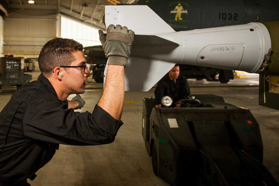 Staff Sgt. Alex Jimenez, 5th Aircraft Maintenance Squadron weapons load crew member, holds an inert GBU-38 munition at Minot Air Force Base, N.D., June 19, 2017. The muntions were inspected, loaded onto a jammer, then secured into an aircraft by the 5th AMXS Global Strike Challenge team during their bomb-loading competition. (U.S. Air Force photo/Senior Airman J.T. Armstrong)